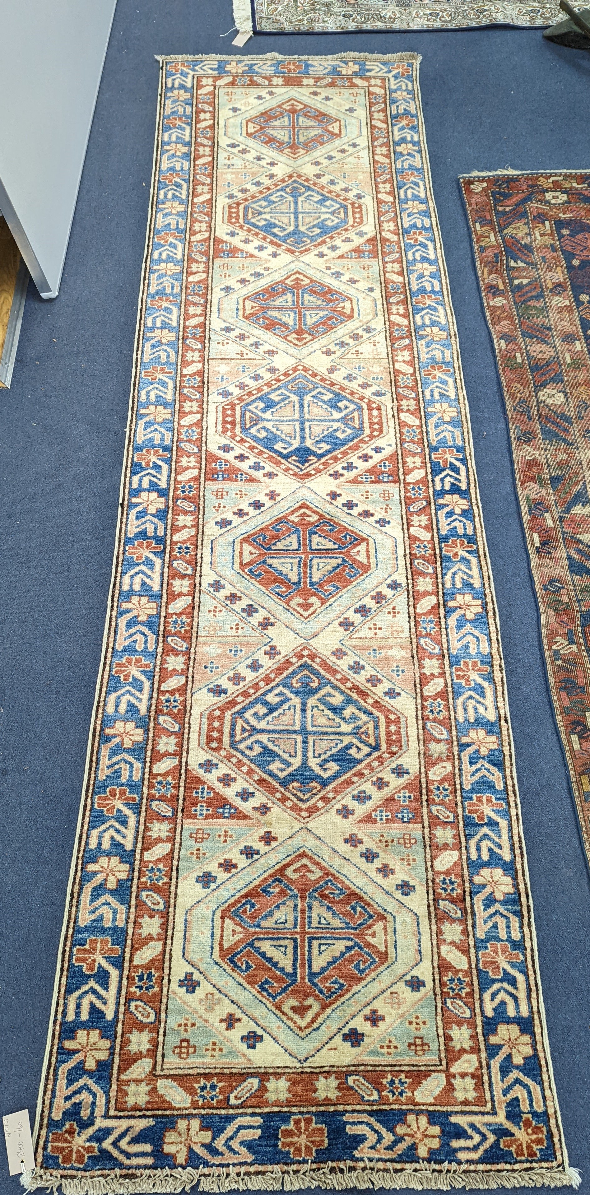 A Caucasian design ivory ground runner, 280 x 70cm